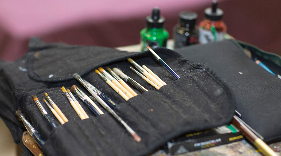 A collection of paintbrushes and paints